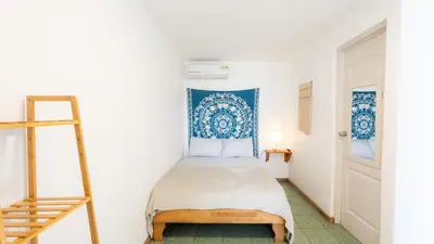 a room with a bed with a ladder and blue tiles at GALA Santa Teresa Apartments 80m from the Beach in Santa Teresa Beach