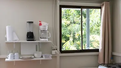 a kitchen with a window and a counter with dishes at GALA Santa Teresa Apartments 80m from the Beach in Santa Teresa Beach