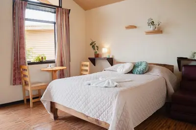 a bedroom with a bed with two towels on it at Cabañas La Hacienda in San Pablo