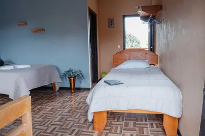 a bedroom with a bed and a window in it at Cabañas La Hacienda in San Pablo