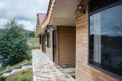 a house with a large window on the side of it at Cabañas La Hacienda in San Pablo