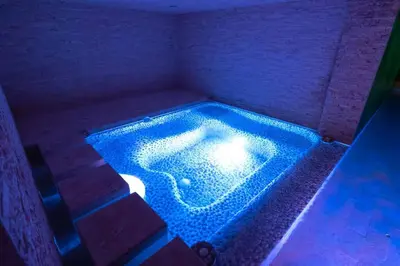 a swimming pool in a room with blue lights at Casa Amarillo Jaco Beach Costa Rica in Jacó