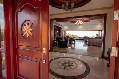 a hallway with a wooden door and a living room at Casa Amarillo Jaco Beach Costa Rica in Jacó