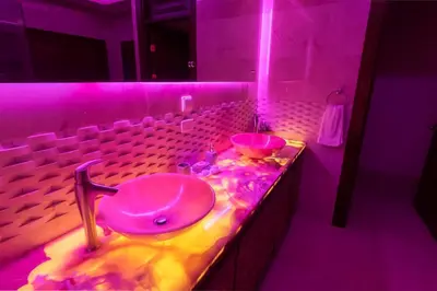 a purple bathroom with a sink and a sink at Casa Amarillo Jaco Beach Costa Rica in Jacó