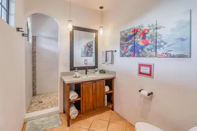 a bathroom with a sink and a shower at Casa Mimosa Poolside in Playa Flamingo