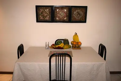 a table with a bowl of fruit on top of it at F&M Guesthouse in San José