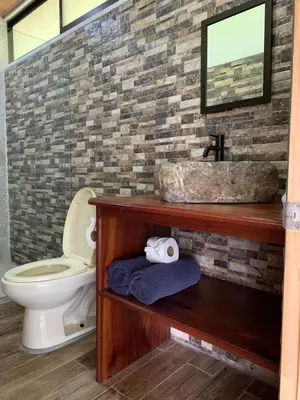 a bathroom with a sink and a toilet at Villas In Sueño in Manuel Antonio