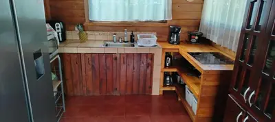 a small kitchen with a sink and a stove at Whale Melody Marabi in Uvita