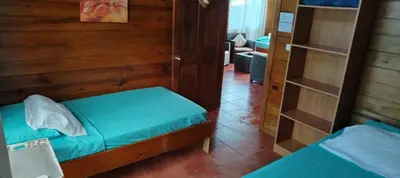 a small room with two beds and a ladder at Whale Melody Marabi in Uvita