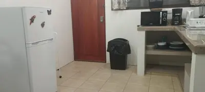 a kitchen with a refrigerator and a trash can at KAPALIZ in Tigre