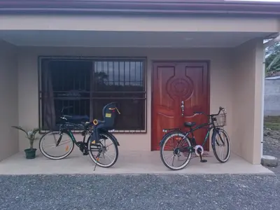 two bikes parked in front of a house with a door at KAPALIZ in Tigre
