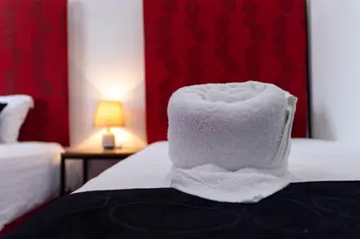 a pile of towels sitting on top of a bed at Brisas del Volcán BnB in Fortuna