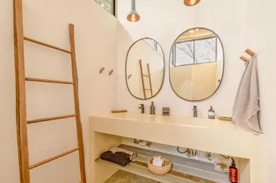 a bathroom with a sink and two mirrors at Casa Arcilla NEW LISTING in Nosara