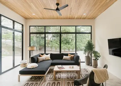 a living room with a couch and a ceiling fan at Casa Arcilla NEW LISTING in Nosara