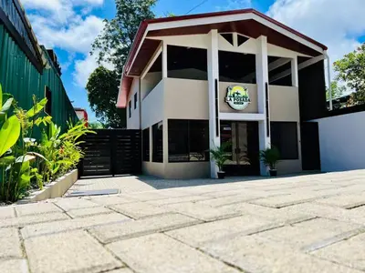 a building with a sign on the front of it at La Posada del Mar in Dominical