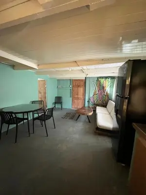 a living room with a table and chairs and a couch at La Posada del Mar in Dominical