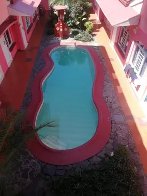 a swimming pool in the middle of a building at ECONOMiKA in Jacó