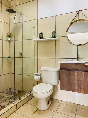 a bathroom with a toilet and a sink and a mirror at Villa Verde II #30 in Tamarindo