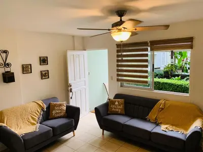 a living room with a couch and a window at Villa Verde II #30 in Tamarindo