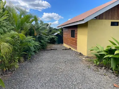 a house with a gravel path next to a building at Cabaña Rural Pura Vida in Fortuna