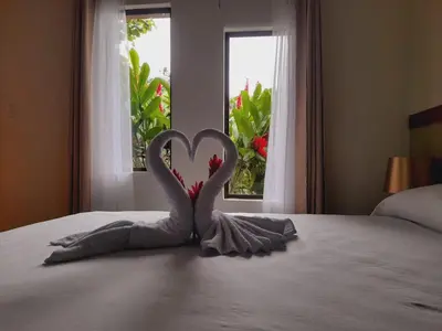 a heart sculpture on a bed in front of a window at Cabaña Rural Pura Vida in Fortuna