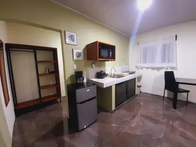 a kitchen with a sink and a counter in a room at Cabaña Rural Pura Vida in Fortuna