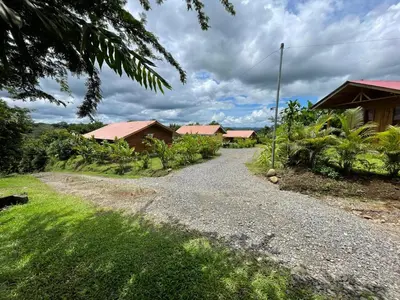a gravel road in front of a group of houses at Cabaña Rural Pura Vida in Fortuna