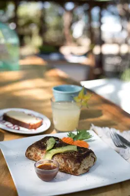 a table with two plates of food on a table at Sueño del Mar Beachfront Hotel in Tamarindo