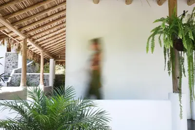 a person walking in a building with plants at Vayu Retreat Villas in Coronado