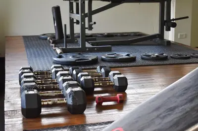a bunch of dumbbells on the floor in a gym at Vayu Retreat Villas in Coronado