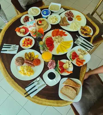 a table full of plates of food on a table at LOP Inn San Jose Aeropuerto - Costa Rica in Ciudad Cariari