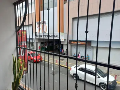 a white car parked in front of a building at W's Hostel in San José
