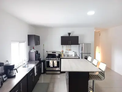a kitchen with a table and a stove top oven at W's Hostel in San José