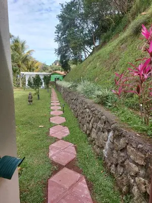 a stone path next to a stone wall at Bungalows Sanlaz in Barrio Jesús