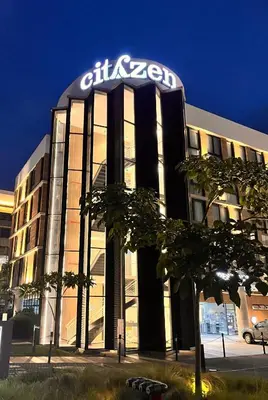 a building with a sign on top of it at Residencias Cityzen cerca del Aeropuerto in Echeverría