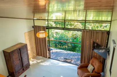 a living room with a large sliding glass door at Modern Loft inside a beautiful farm in General Viejo