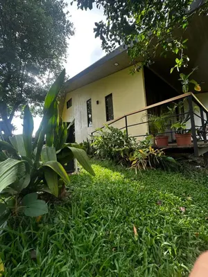 a house with a yard with green grass at Modern Loft inside a beautiful farm in General Viejo
