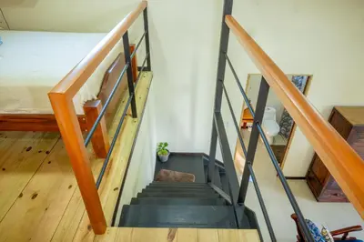 a staircase leading up to a bedroom in a house at Modern Loft inside a beautiful farm in General Viejo