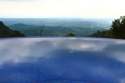 a swimming pool with a view of the mountains at Casa Altamar in Jacó