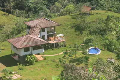 an aerial view of a house on a hill with a swimming pool at Casa Altamar in Jacó