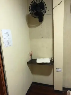 a corner of a room with a fan on a wall at #2 private room close to airport in Alajuela City