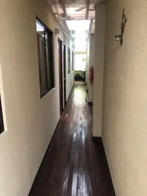 an empty hallway of an office building with a wooden floor at #2 private room close to airport in Alajuela City
