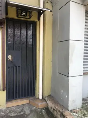a black door on the side of a building at #2 private room close to airport in Alajuela City