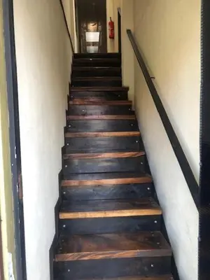 a staircase with wooden steps in a building at #2 private room close to airport in Alajuela City