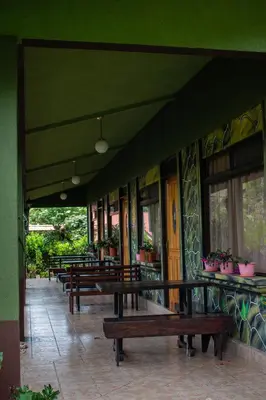 a row of benches sitting outside of a building at Cabinas las Manzanas Bed y Breakfast in El Copey