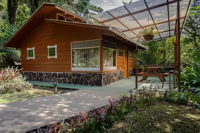 a small house with a glass roof and a patio at Los Pinos Cabins & Reserve in Monteverde Costa Rica