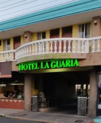 a hotel la guaza with a balcony on top of it at Hotel La Guaria in Liberia