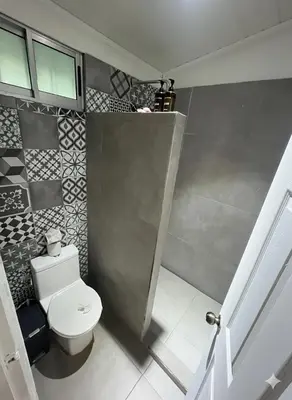 a bathroom with a white toilet in a room at Refugio Surf Lodge in Tamarindo