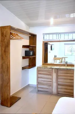 a kitchen with a counter and a sink in a room at Refugio Surf Lodge in Tamarindo