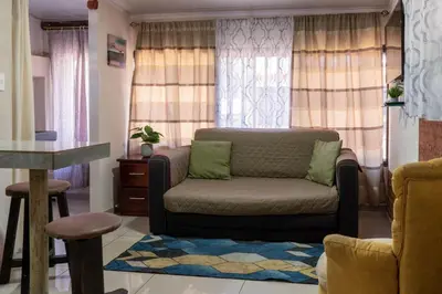 a living room with a couch and a table at Nice private apartment studio to discover CR in Alajuela City